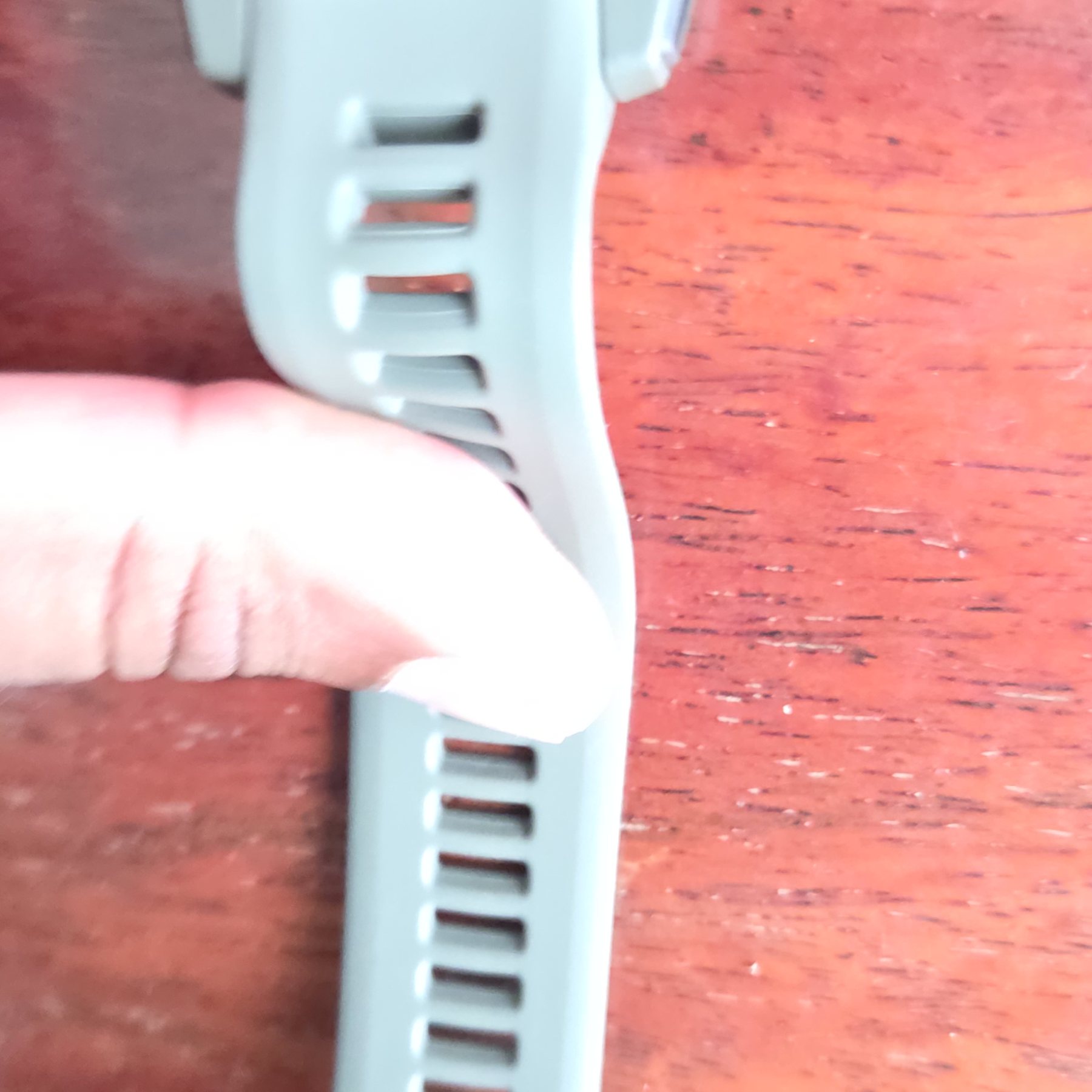 Detail of the ribbed sage green silicone strap.