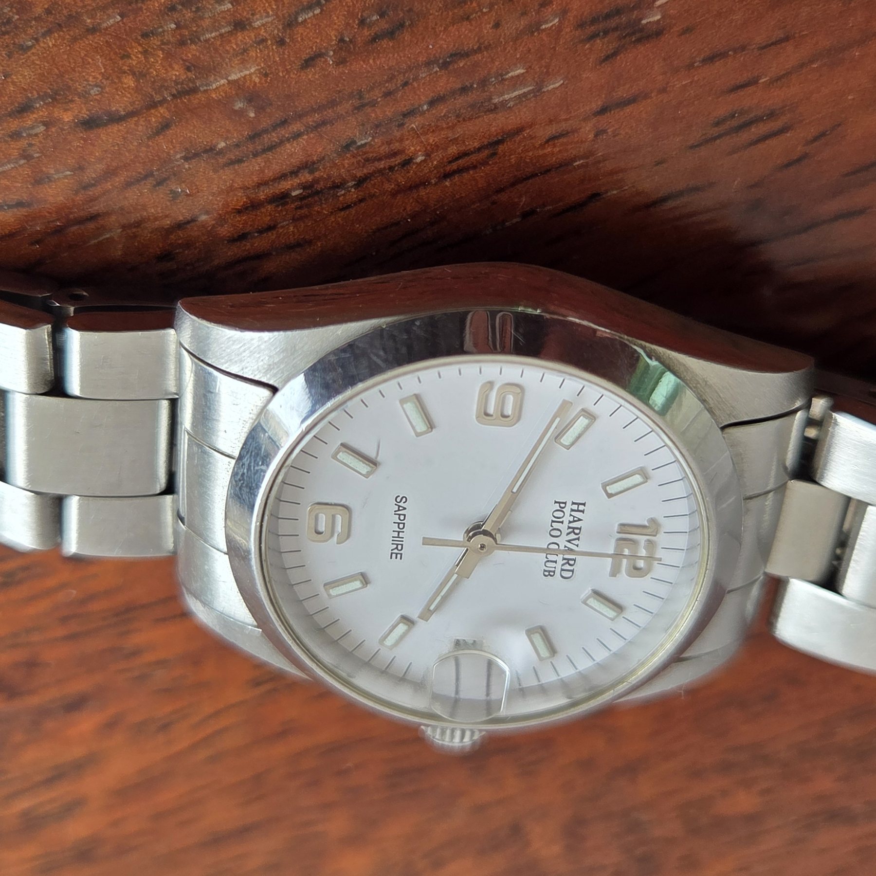 A low three-quarter view showing the case profile and the bracelet.