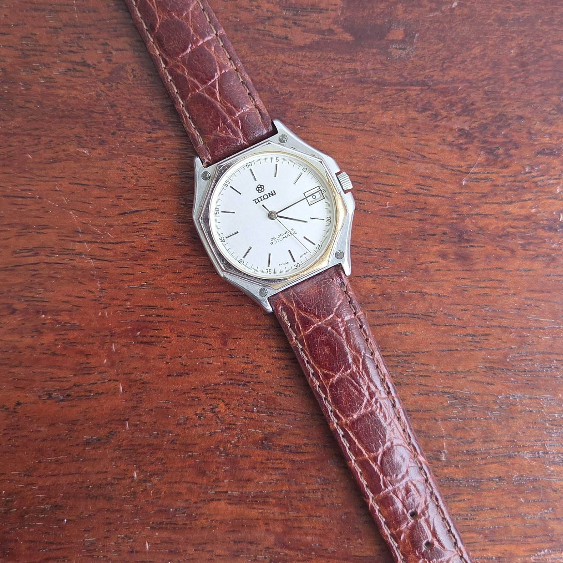 The whole watch laid out flat with the alligator strap extended.