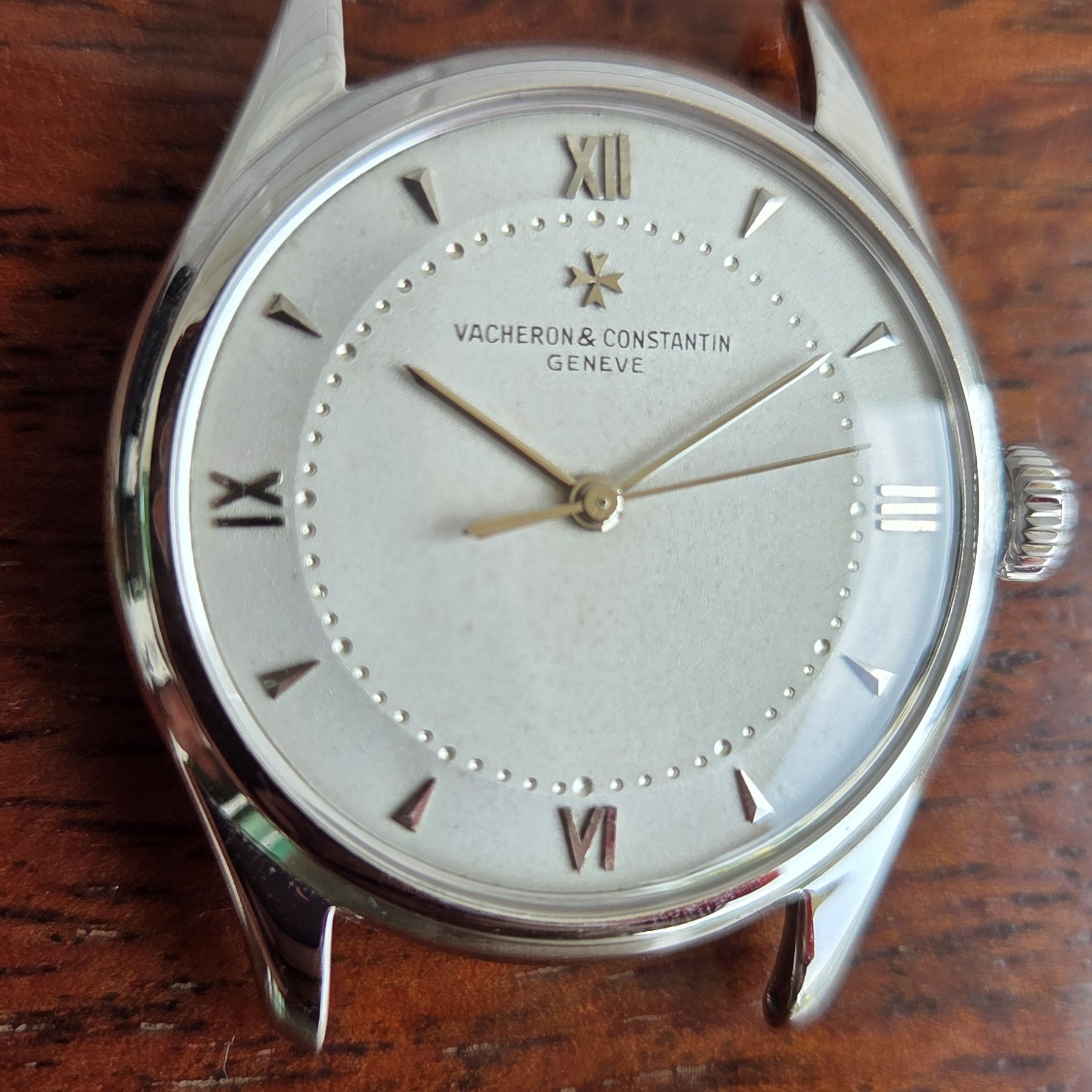 The silvered dial square-on on its burgundy alligator strap.