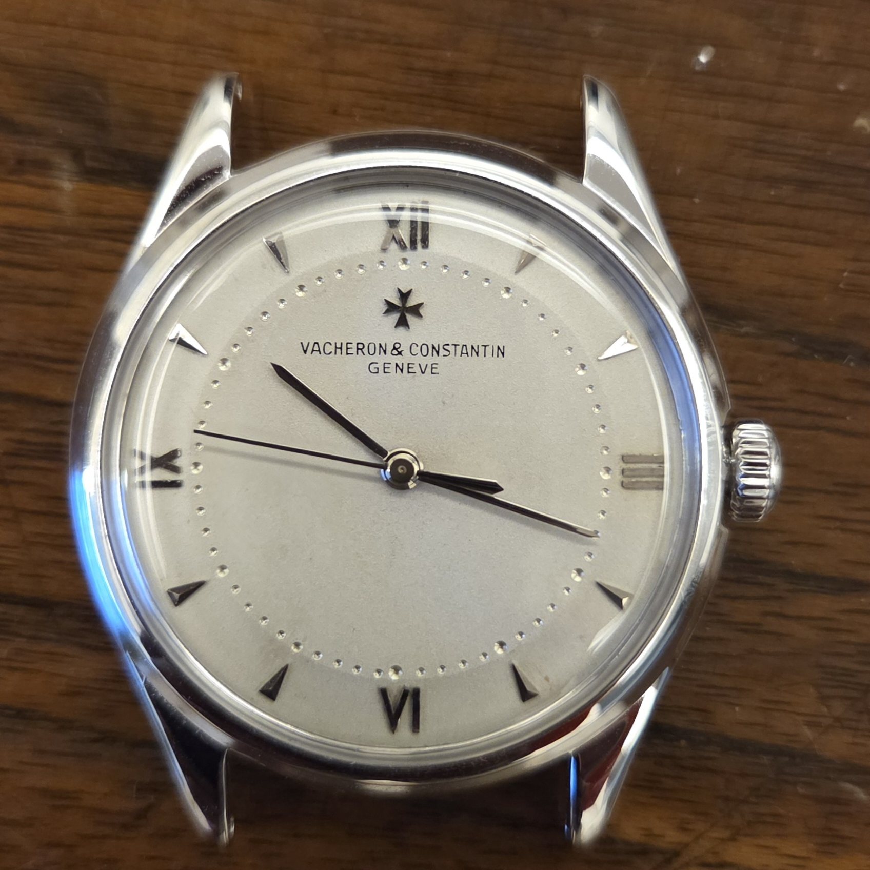 A closer square-on view of the same dial, with the applied Maltese cross and the beaded minute track.