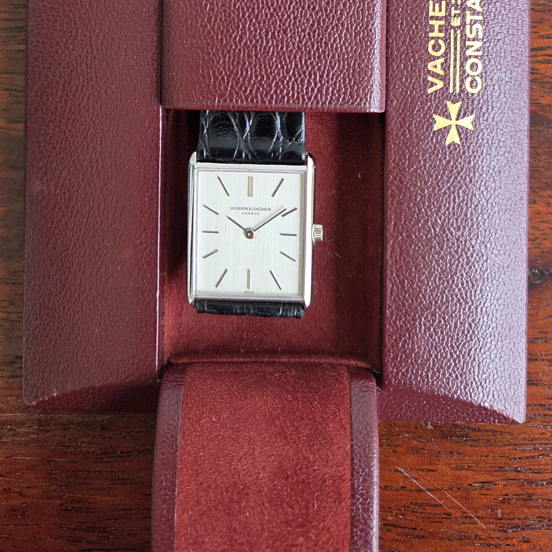 The watch resting inside its original burgundy Vacheron Constantin pouch.