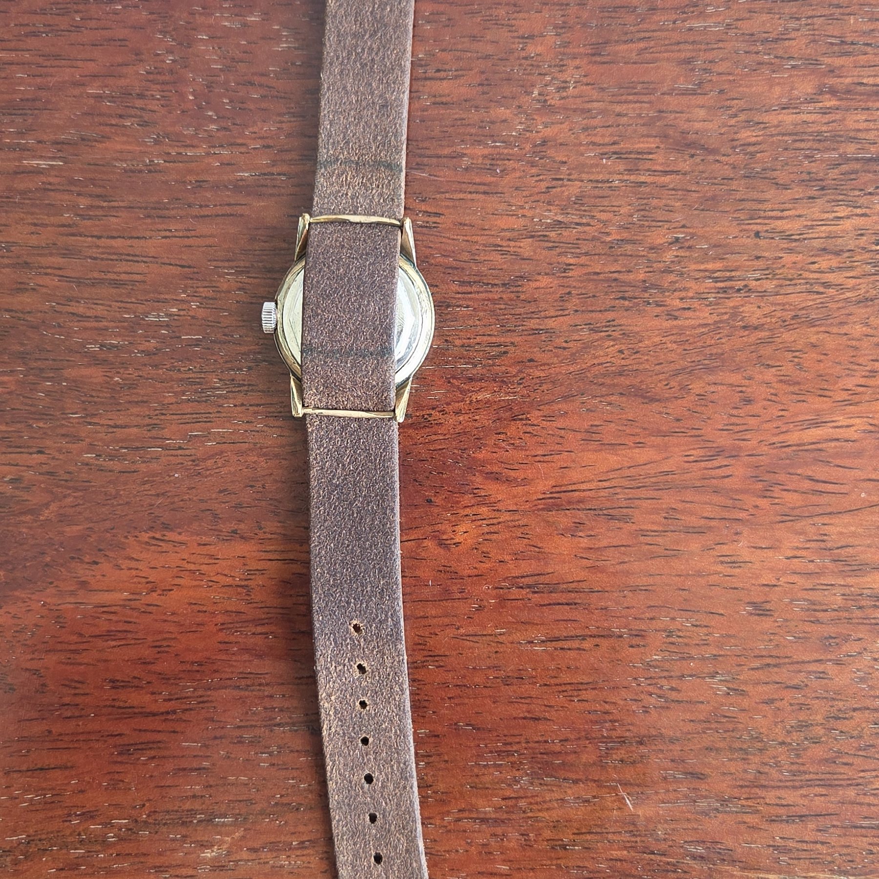 The whole watch laid out flat with the strap extended.